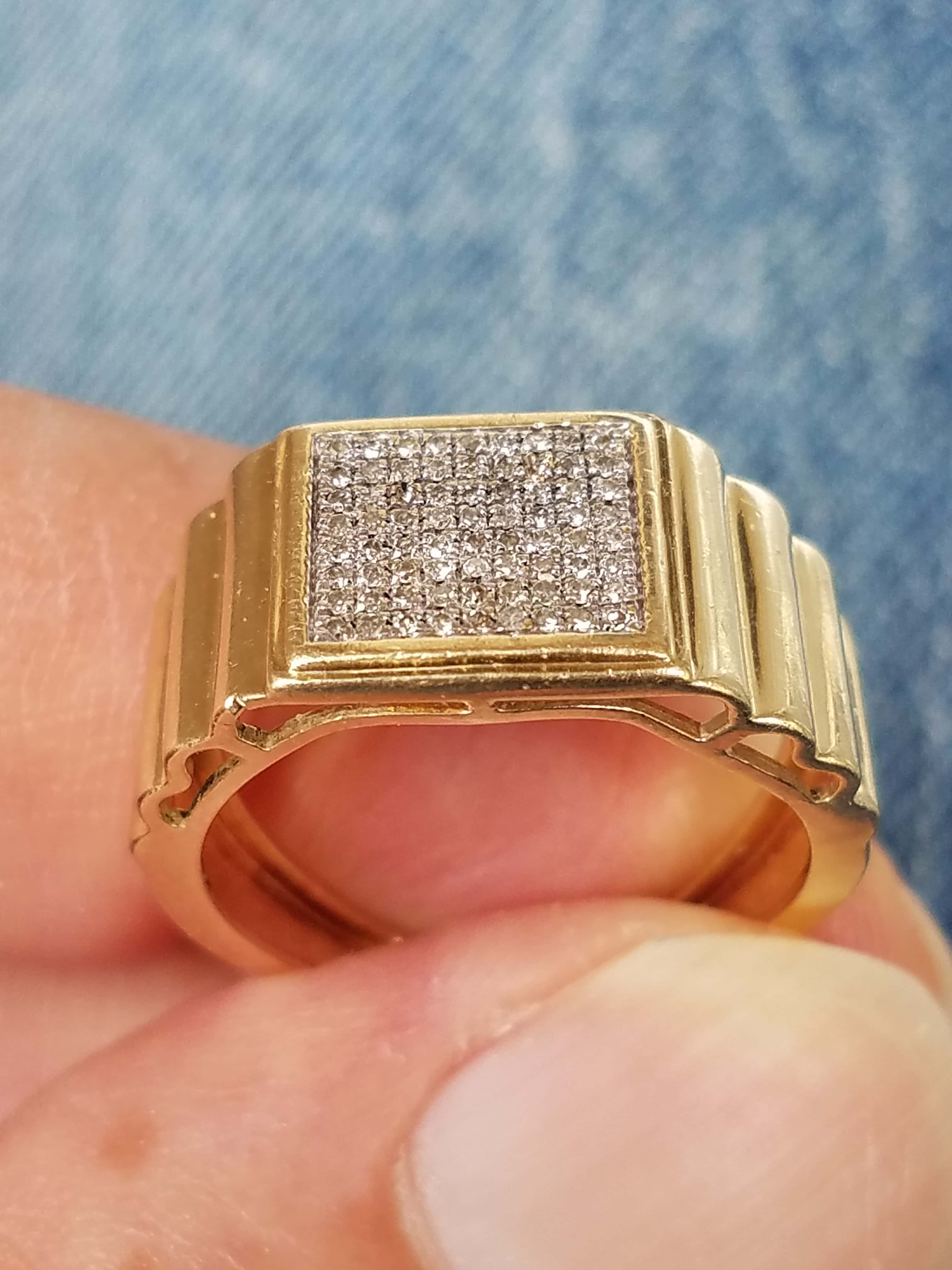 Held Between Finger and Thumb in Front of Garrett Ace Apex Metal Detector and Grass Background