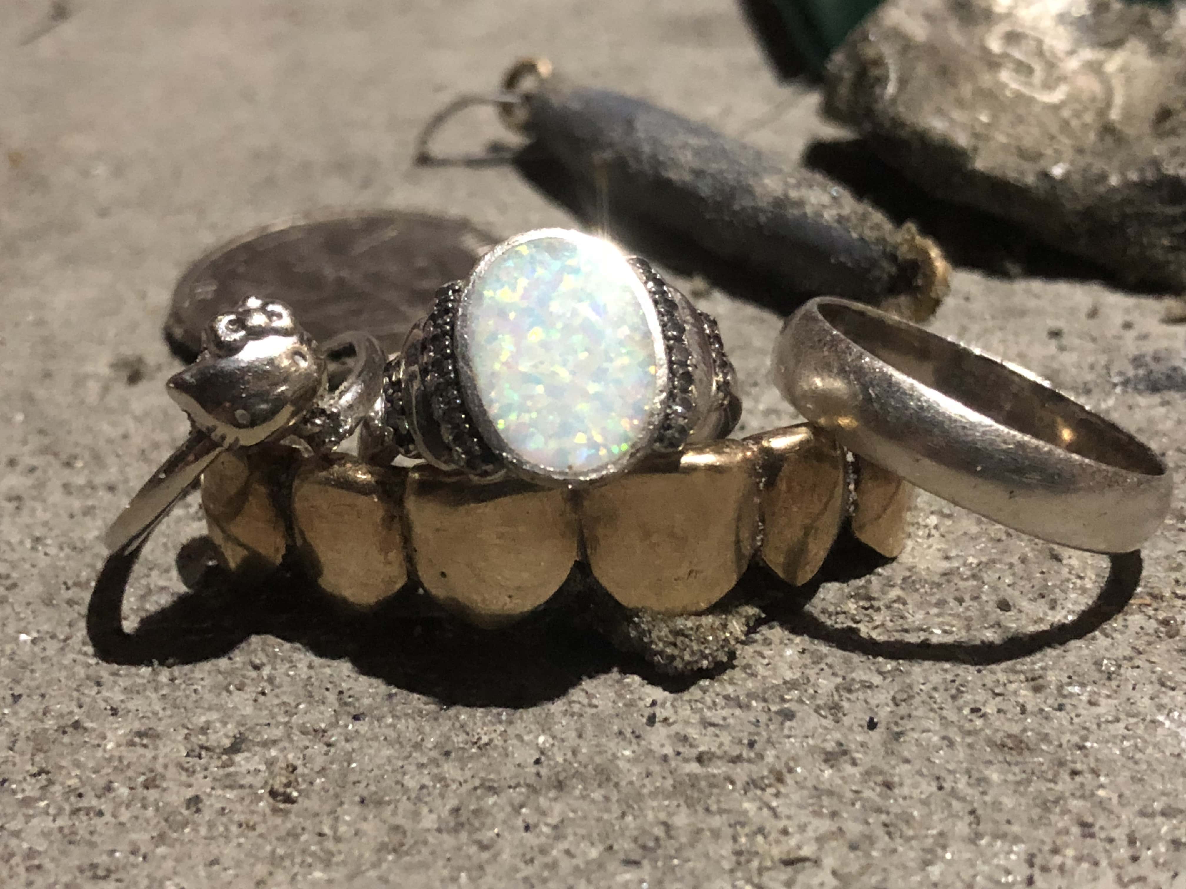 Silver Rings with Gold Teeth Bridge on Sandy Beach Background