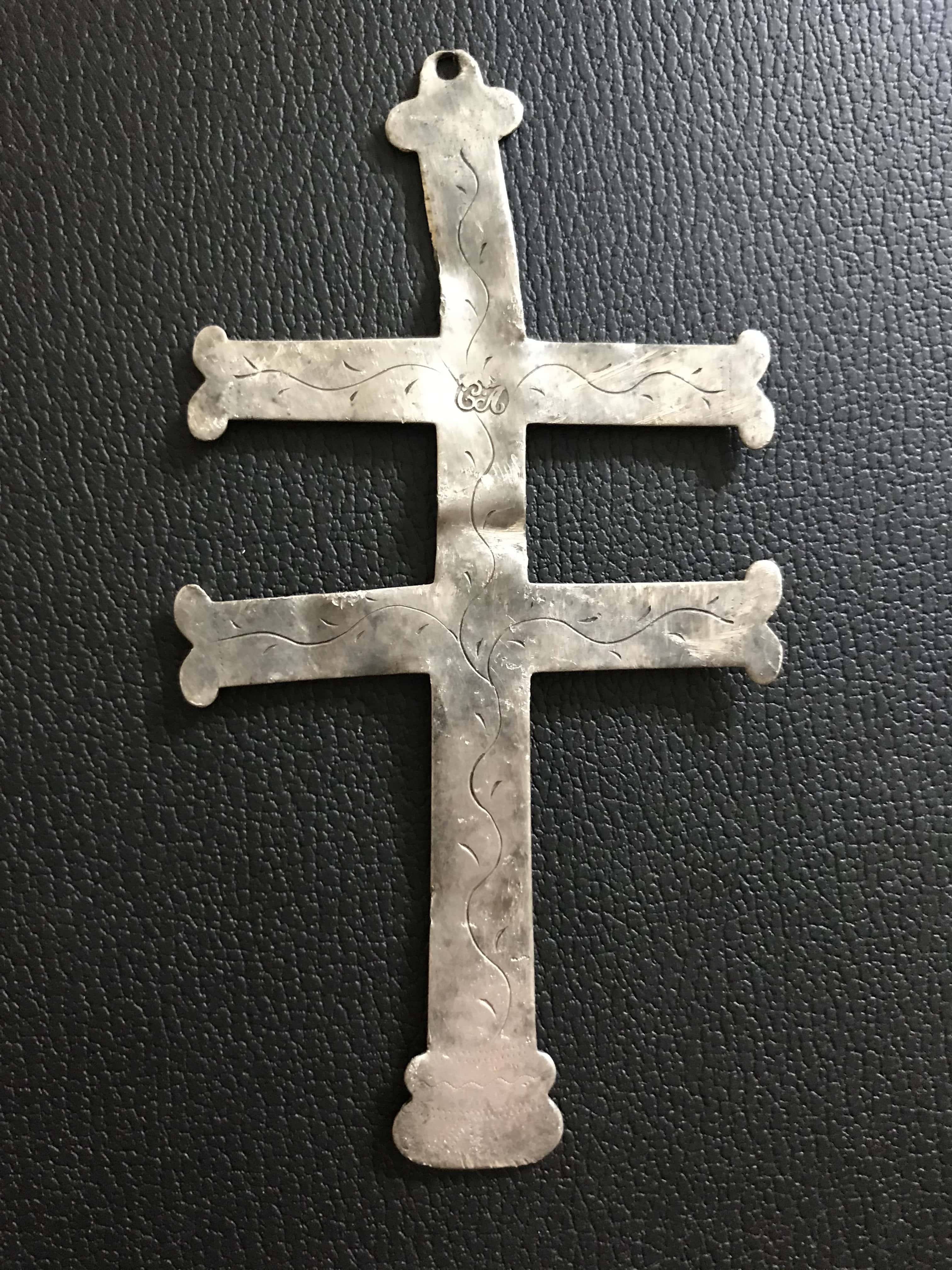 Silver Trade Cross with CA imprinted at Center and Wavy Vine-like Lines Up and Down the Cross