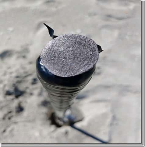 Carlos and Juana 2 Spanish Reale Coin Balanced on a the end of a Sand Scoop with Sand in Background