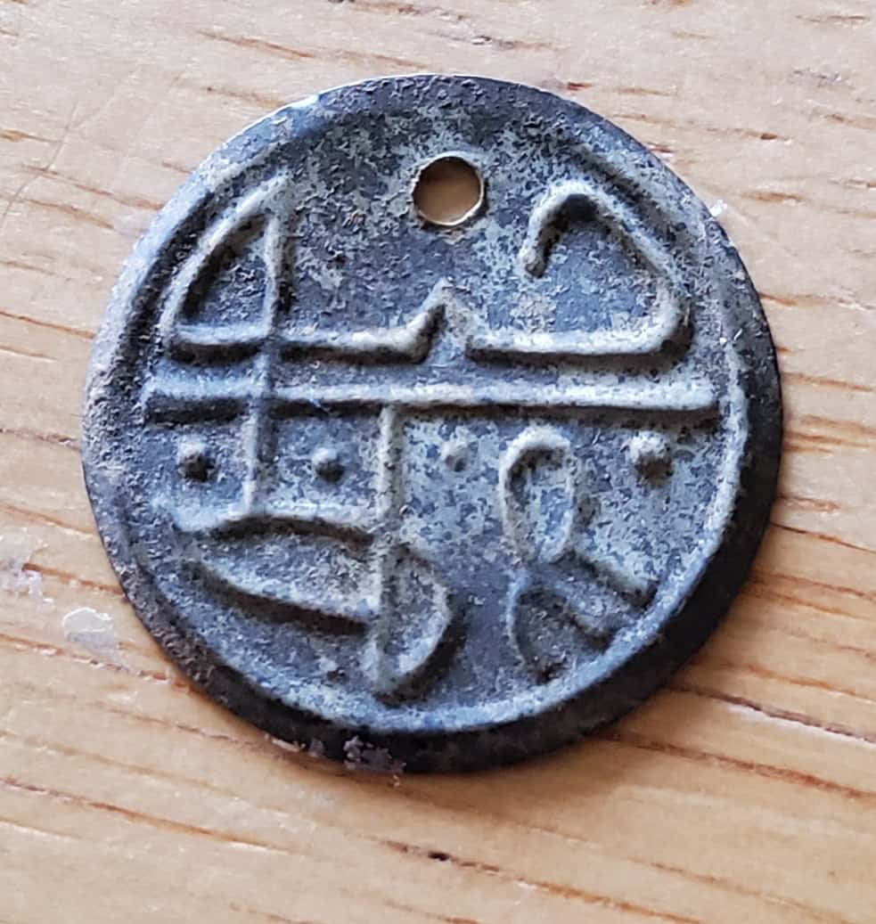 Bracelet Inlaid with Various Stones in Blue and Green on Silver Resting on Red Cloth