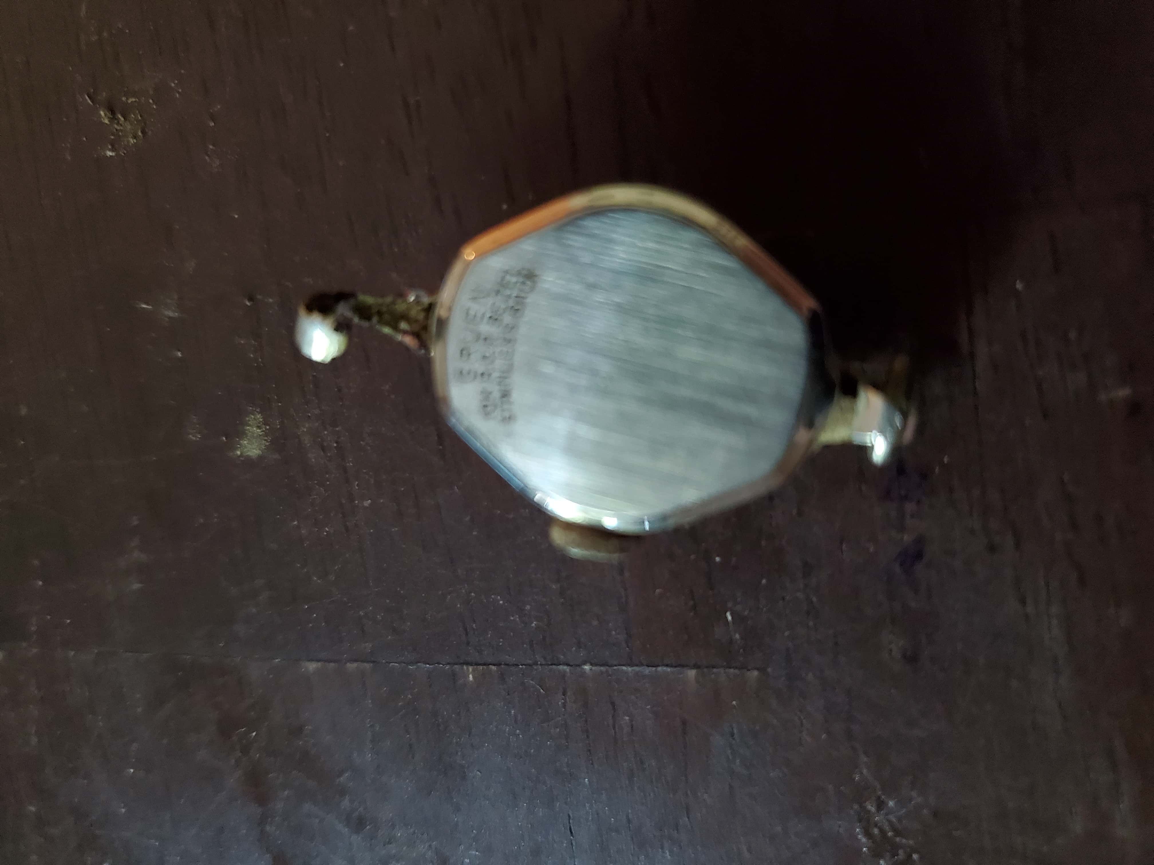 German Ladies Wristwatch Back on Wooden Background