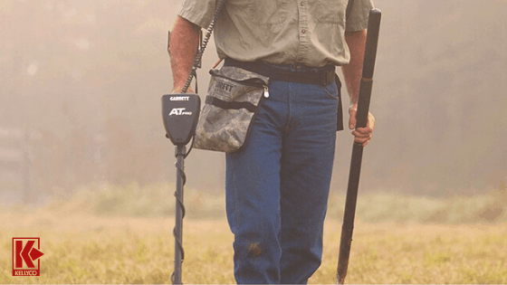 A detectorist using the Garrett AT Pro detector in a field.